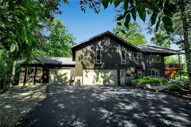 17 Quail, Orchard Park, NY 14127 - view of front of house with driveway, stairs, an attached garage, and a shingled roof