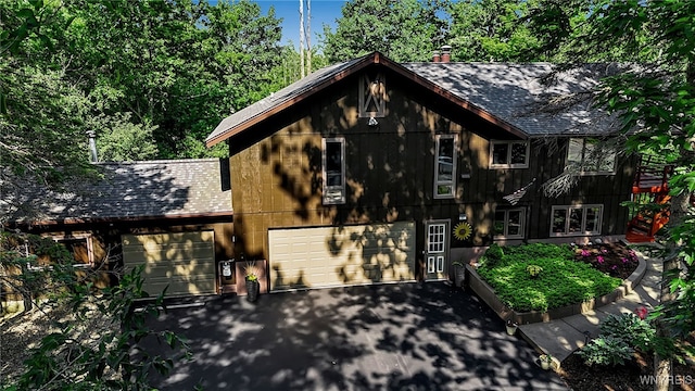 17 Quail, Orchard Park, NY 14127 - view of front facade featuring a shingled roof, asphalt driveway, and an attached garage