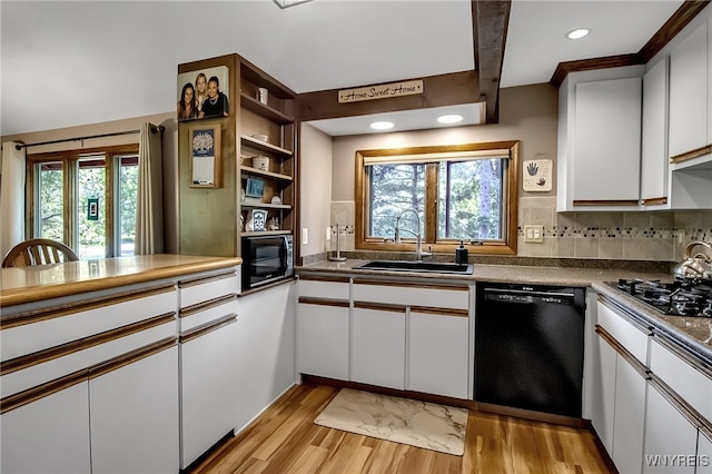 17 Quail, Orchard Park, NY 14127 - kitchen with black appliances, light wood-style floors, white cabinets, open shelves, and backsplash