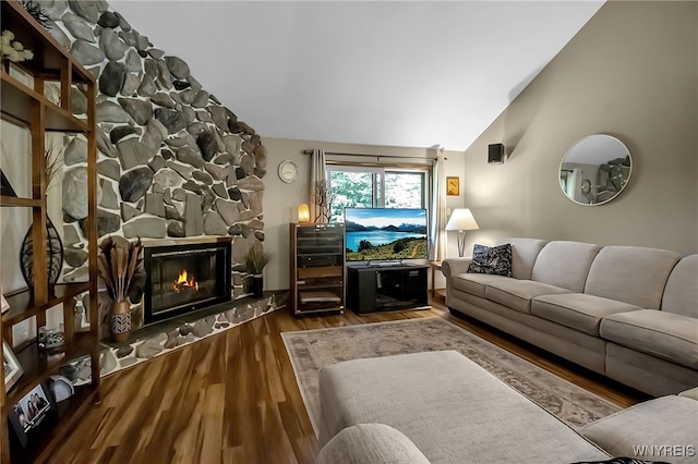 17 Quail, Orchard Park, NY 14127 - living room featuring lofted ceiling, wood finished floors, and a stone fireplace