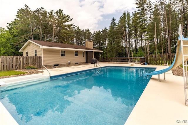 217 Sloperville Rd, Albion, NY 13302 - view of swimming pool featuring a water slide, view of wooded area, and a diving board