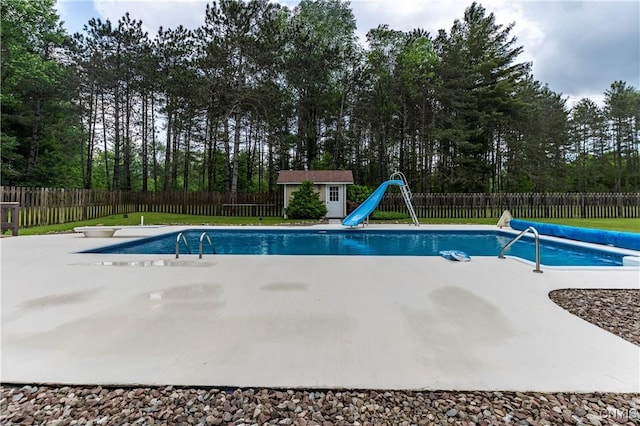 217 Sloperville Rd, Albion, NY 13302 - view of swimming pool with a water slide, an outbuilding, a fenced backyard, a patio area, and view of scattered trees