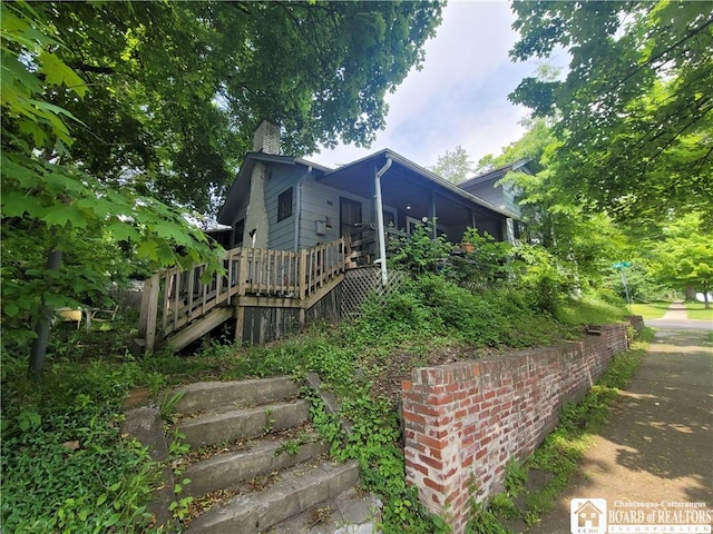 315 E 6th St, Jamestown, NY 14701 - view of side of property featuring a deck, a chimney, and stairs