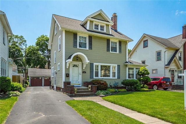 207 Wimbledon Rd, Irondequoit, NY 14617 - american foursquare style home with a chimney, an outbuilding, a garage, and a front lawn