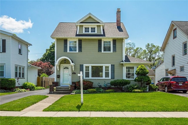 207 Wimbledon Rd, Irondequoit, NY 14617 - view of front of home with a chimney, a front lawn, and a shingled roof