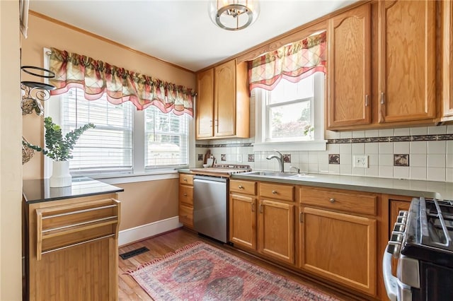 207 Wimbledon Rd, Irondequoit, NY 14617 - kitchen featuring stainless steel dishwasher, range with gas cooktop, decorative backsplash, plenty of natural light, and ornamental molding