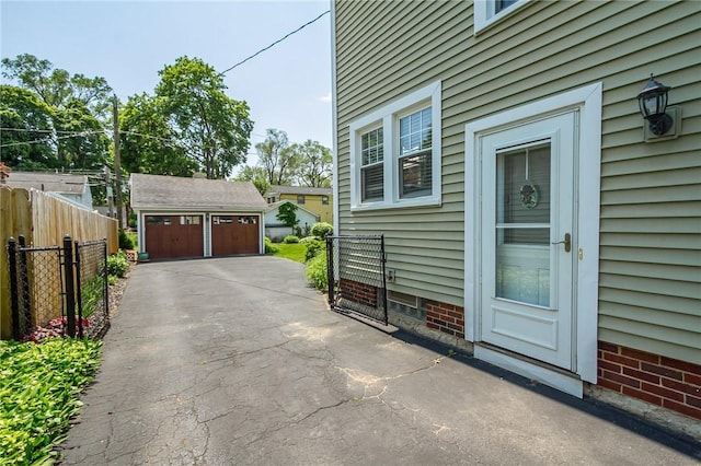 207 Wimbledon Rd, Irondequoit, NY 14617 - view of home's exterior with a detached garage and an outdoor structure