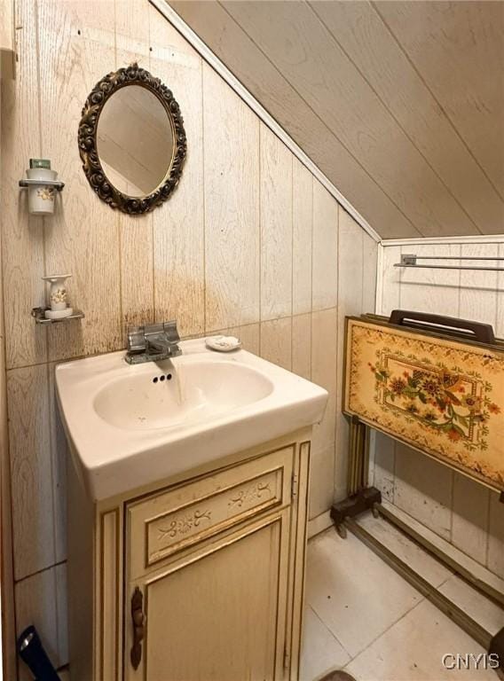 9067 Main St, Brookfield, NY 13418 - bathroom with vanity, lofted ceiling, and wooden walls