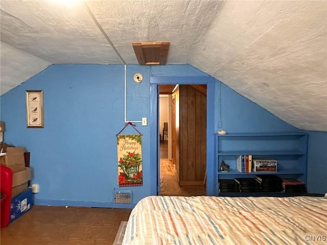 9067 Main St, Brookfield, NY 13418 - bedroom with vaulted ceiling and a textured ceiling