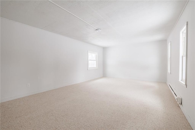 123 Rauber St, Rochester, NY 14605 - carpeted empty room with a baseboard radiator and a textured ceiling