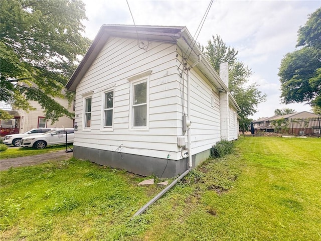123 Rauber St, Rochester, NY 14605 - view of side of home featuring a yard and a chimney