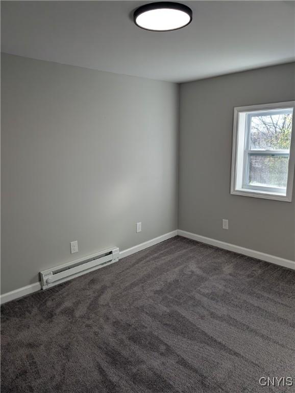 145 Creamery Rd Unit B, Scriba, NY 13126 - unfurnished room with a baseboard radiator and dark carpet