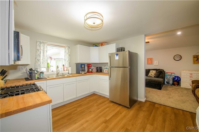 145 Creamery Rd Unit B, Scriba, NY 13126 - kitchen with freestanding refrigerator, wood counters, open floor plan, light wood-style flooring, and white cabinetry