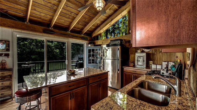 8567 Glen Rd, Rushford, NY 14777 - kitchen featuring a wooden ceiling with exposed beams, freestanding refrigerator, light wood-style flooring, a ceiling fan, and stone counters