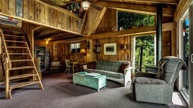 8567 Glen Rd, Rushford, NY 14777 - carpeted living area with wood walls, a ceiling fan, high vaulted ceiling, and a wood ceiling with exposed beams