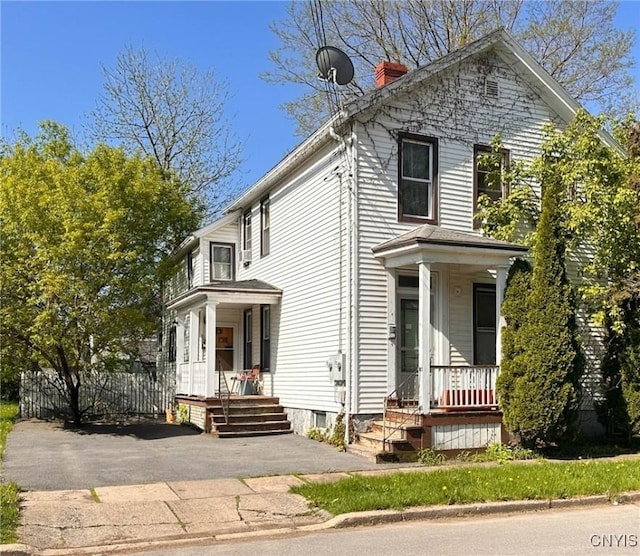 711 Stevens St, Utica, NY 13502 - view of front of house with covered porch and a chimney