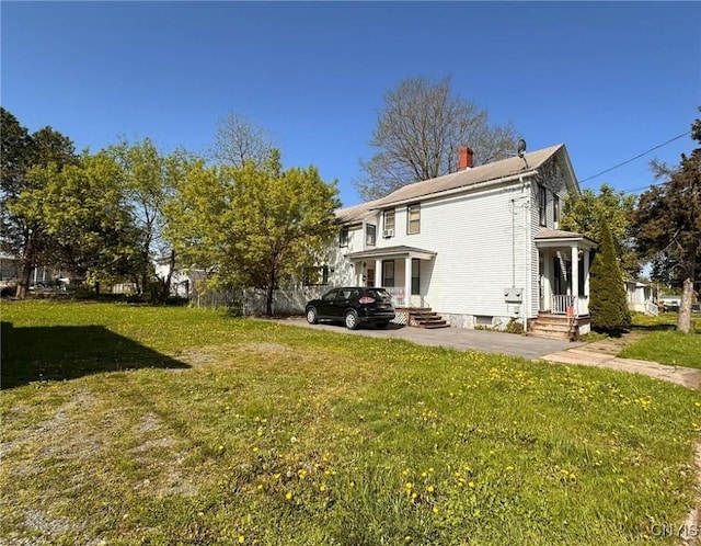 711 Stevens St, Utica, NY 13502 - rear view of house with a yard and a chimney