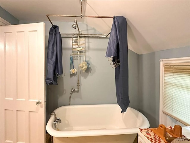 711 Stevens St, Utica, NY 13502 - bathroom with a freestanding bath and vaulted ceiling
