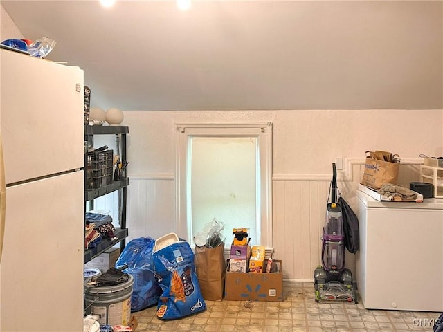 711 Stevens St, Utica, NY 13502 - kitchen featuring freestanding refrigerator, washer / clothes dryer, a wainscoted wall, and wooden walls