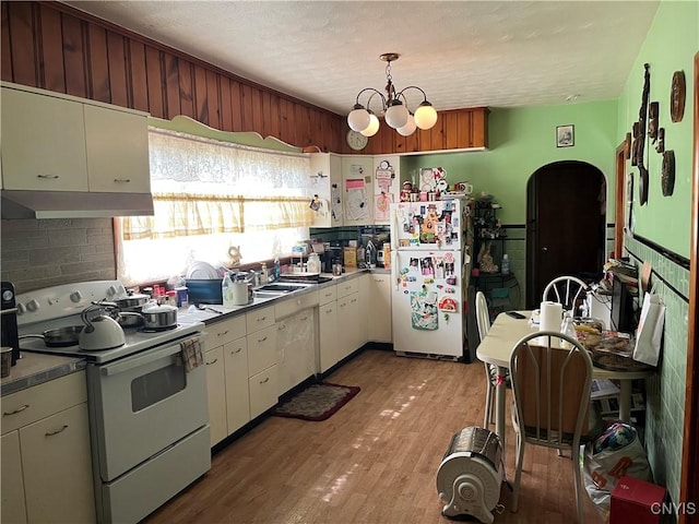 711 Stevens St, Utica, NY 13502 - kitchen featuring white appliances, range hood, white cabinets, light wood-style flooring, and a textured ceiling