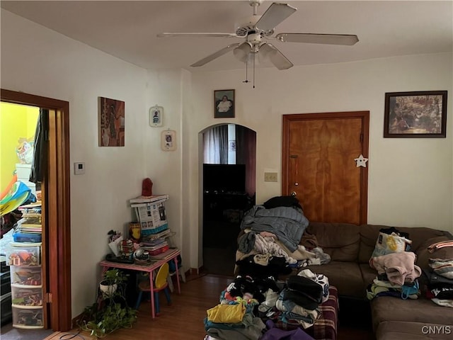 711 Stevens St, Utica, NY 13502 - living area with ceiling fan, wood finished floors, and arched walkways