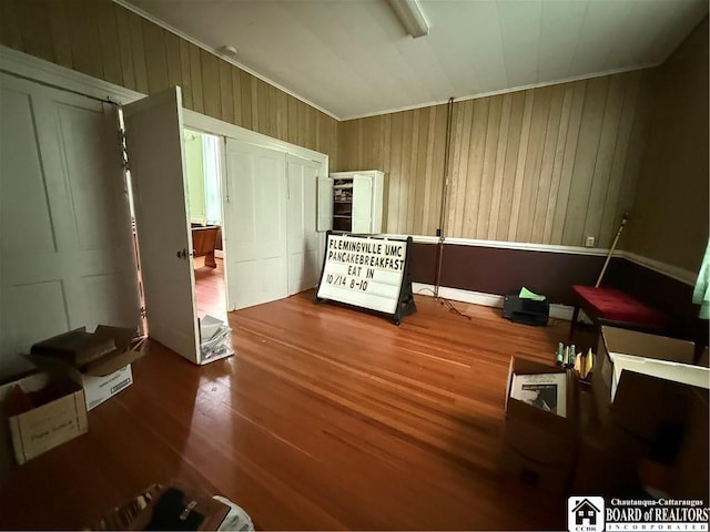 540 W Creek Rd, Owego, NY 13827 - bedroom featuring wood finished floors, wood walls, and ornamental molding