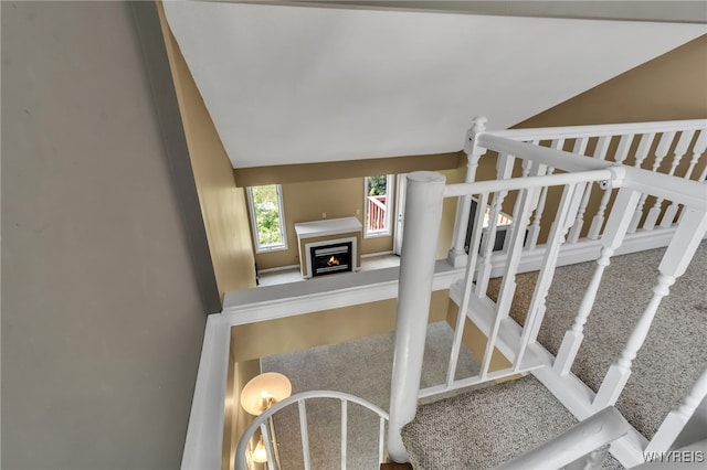 5 Keph Dr Unit 8, Amherst, NY 14228 - stairway featuring a warm lit fireplace, carpet, and lofted ceiling