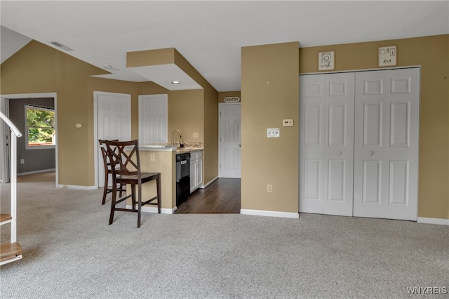 5 Keph Dr Unit 8, Amherst, NY 14228 - kitchen with dark colored carpet, black dishwasher, light countertops, and a breakfast bar area