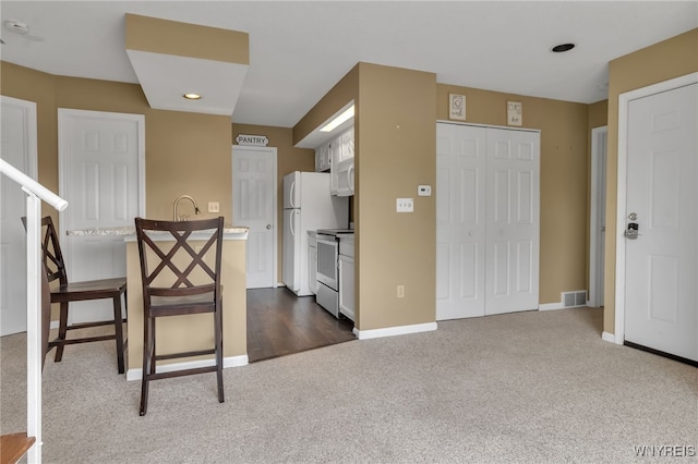 5 Keph Dr Unit 8, Amherst, NY 14228 - kitchen featuring dark carpet, white appliances, recessed lighting, light countertops, and white cabinetry