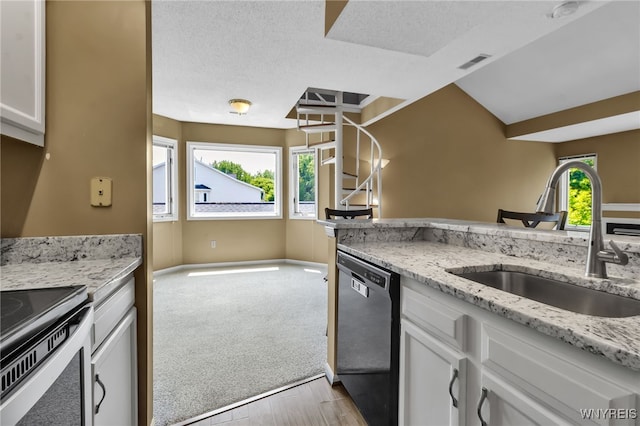 5 Keph Dr Unit 8, Amherst, NY 14228 - kitchen featuring dishwasher, light wood-style flooring, white cabinetry, light stone counters, and a textured ceiling