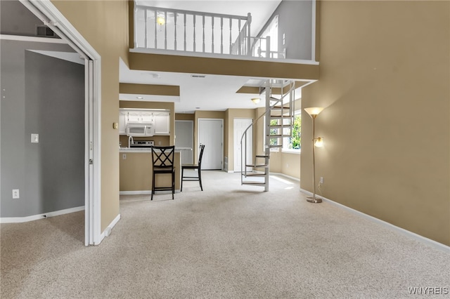 5 Keph Dr Unit 8, Amherst, NY 14228 - unfurnished living room featuring a high ceiling and light colored carpet