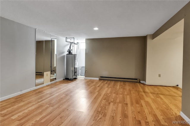 5 Keph Dr Unit 8, Amherst, NY 14228 - empty room featuring baseboard heating, light wood-style flooring, recessed lighting, and a baseboard heating unit