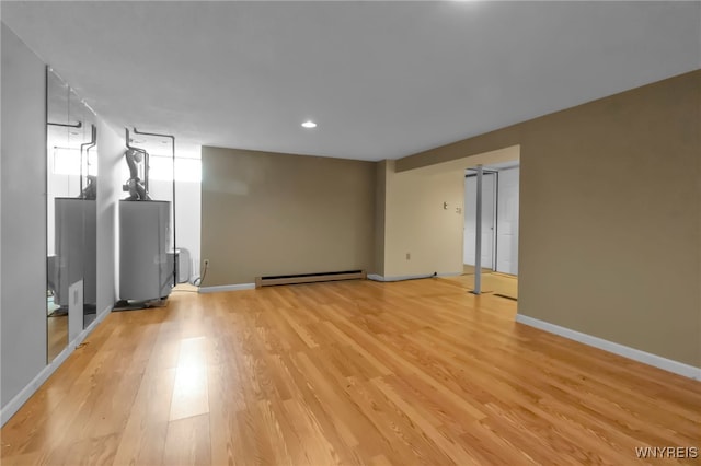 5 Keph Dr Unit 8, Amherst, NY 14228 - spare room with baseboard heating, light wood-style floors, recessed lighting, and water heater
