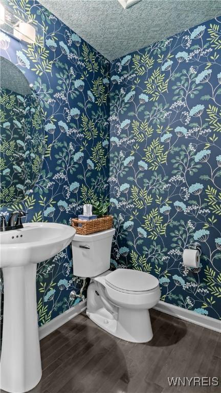 127 Boxelder Ln, Amherst, NY 14228 - bathroom featuring wallpapered walls, wood finished floors, and a textured ceiling