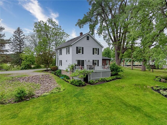 38 E Ave, Murray, NY 14470 - back of property featuring a chimney, a yard, and a deck