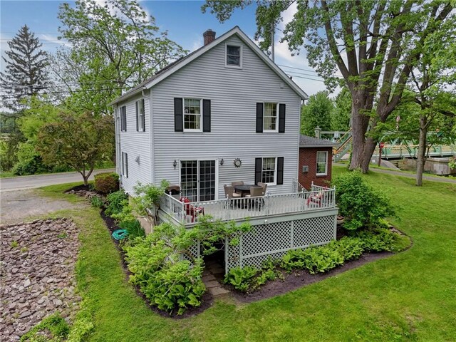 38 E Ave, Murray, NY 14470 - rear view of house with a yard, a chimney, and a deck