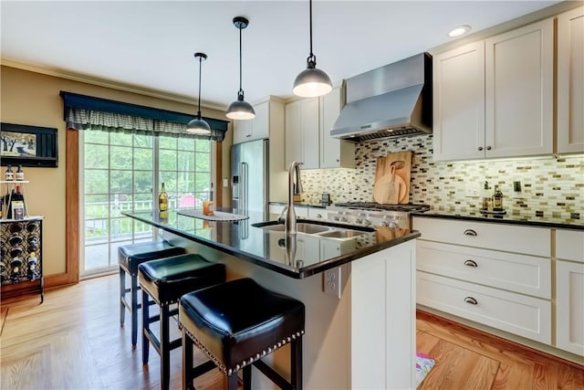 38 E Ave, Murray, NY 14470 - kitchen with wall chimney exhaust hood, high quality fridge, dark countertops, a kitchen breakfast bar, and crown molding