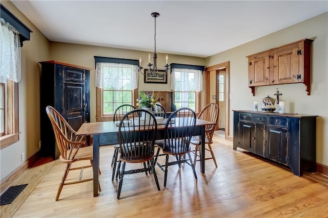 38 E Ave, Murray, NY 14470 - dining area featuring light wood-style flooring and a chandelier