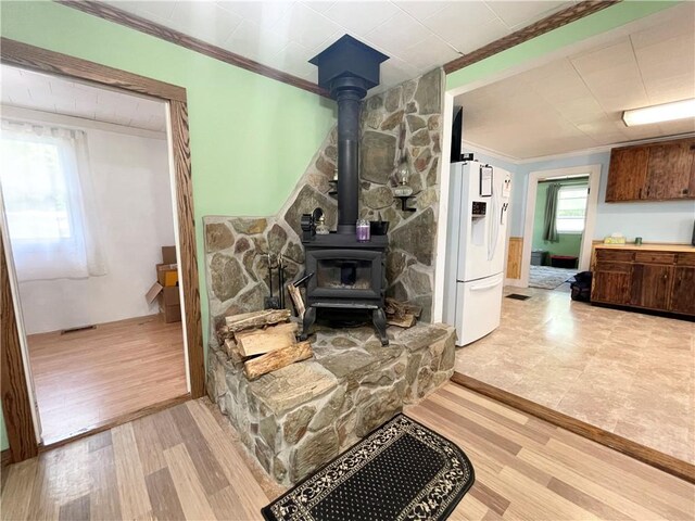 1663 Bingham Rd, Keating Town, PA 16726 - living room featuring light wood finished floors, ornamental molding, and a wood stove