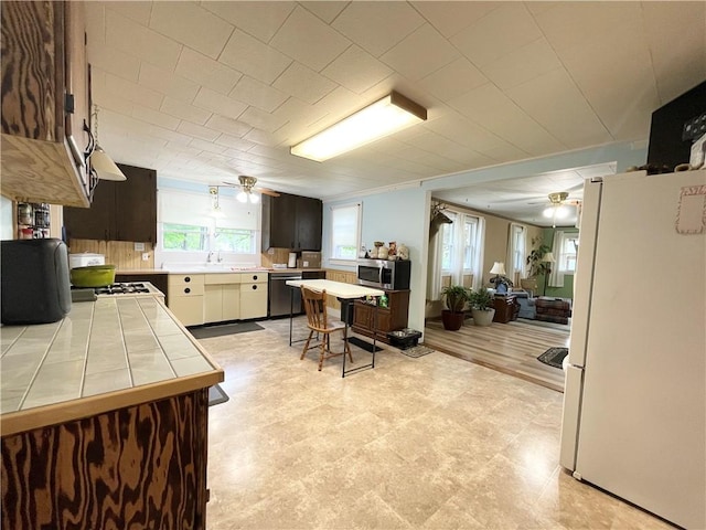1663 Bingham Rd, Keating Town, PA 16726 - kitchen featuring white appliances, tile counters, ceiling fan, open floor plan, and light floors