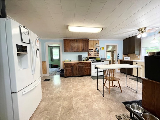 1663 Bingham Rd, Keating Town, PA 16726 - kitchen with white appliances, light countertops, ornamental molding, dark brown cabinetry, and ceiling fan