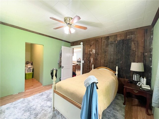 1663 Bingham Rd, Keating Town, PA 16726 - bedroom with crown molding, wood walls, wood finished floors, and ceiling fan