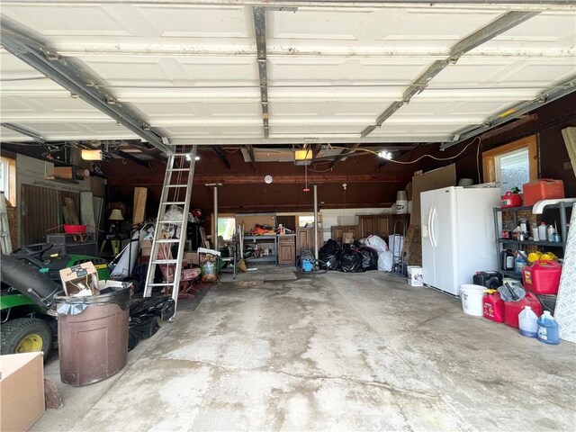 1663 Bingham Rd, Keating Town, PA 16726 - garage featuring white refrigerator with ice dispenser and a garage door opener
