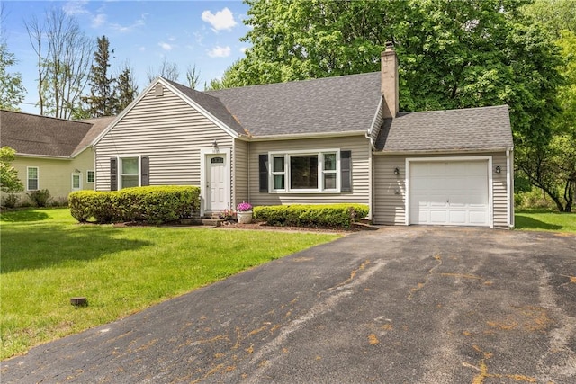 1617 Five Mile Line Rd, Penfield, NY 14526 - view of front of property featuring an attached garage, asphalt driveway, a chimney, a front yard, and a shingled roof