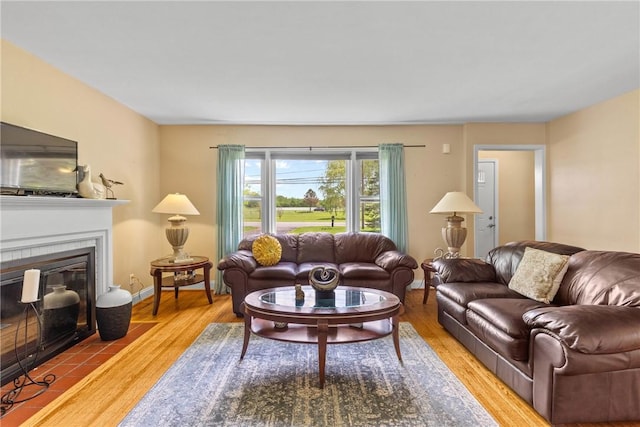1617 Five Mile Line Rd, Penfield, NY 14526 - living area with wood finished floors and a tiled fireplace