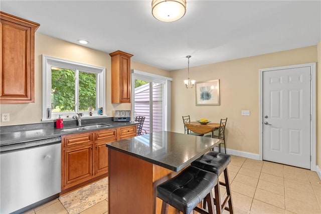 1617 Five Mile Line Rd, Penfield, NY 14526 - kitchen with stainless steel dishwasher, a breakfast bar area, brown cabinets, and light tile patterned flooring