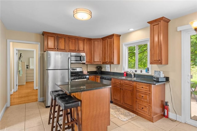 1617 Five Mile Line Rd, Penfield, NY 14526 - kitchen with stainless steel appliances, healthy amount of natural light, light tile patterned floors, a kitchen bar, and recessed lighting