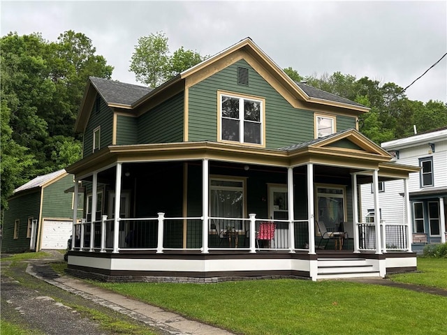 15 Water St, Worcester, NY 12197 - rear view of house with a porch, an outdoor structure, a yard, and a garage