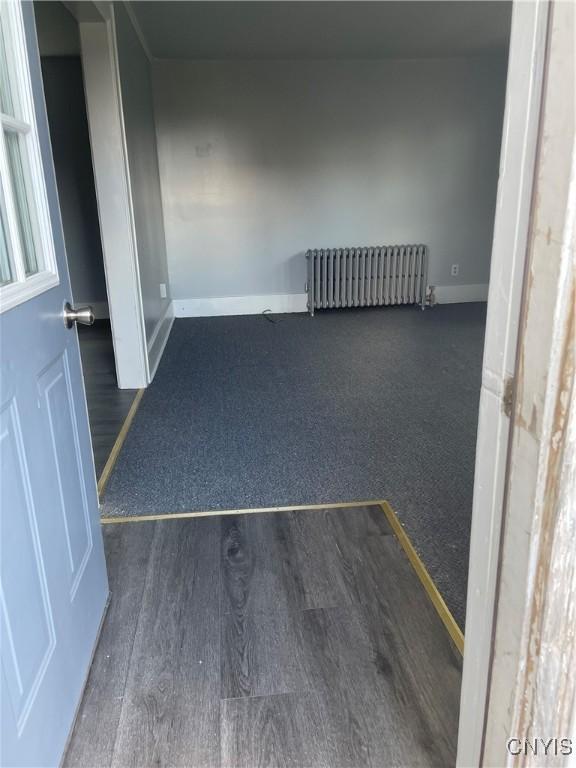 216 S 2nd St, Fulton, NY 13069 - unfurnished room featuring radiator and wood finished floors