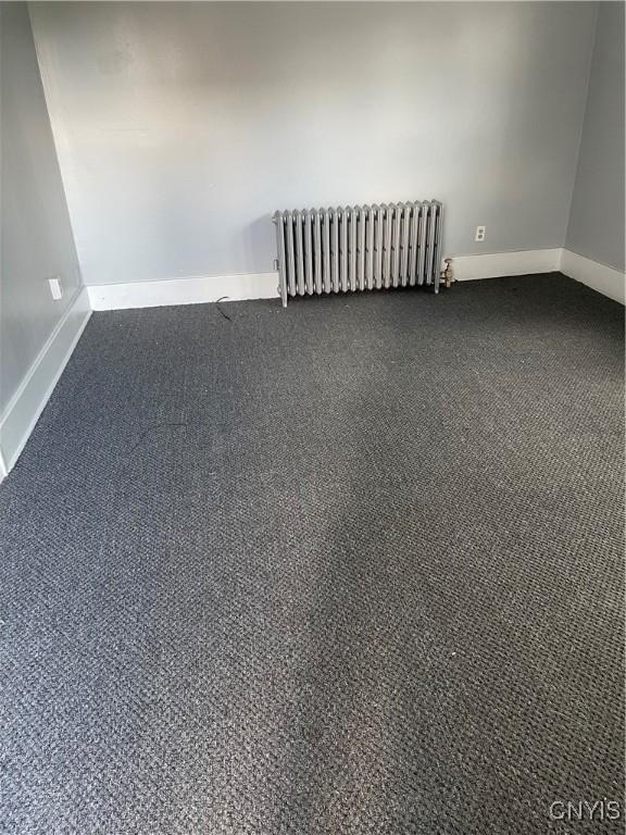 216 S 2nd St, Fulton, NY 13069 - unfurnished room with radiator and carpet flooring